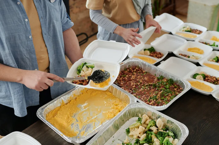 Image of volunteers packing up meals for the Gift of Good Food Fundraiser in Fernwood Victoria BC